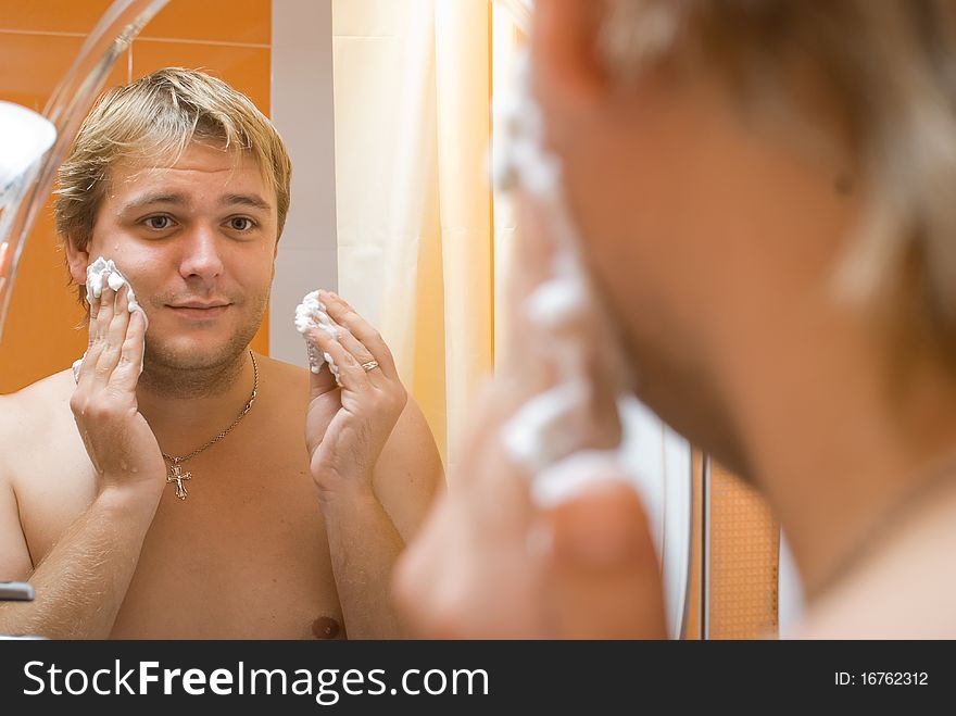 Man shaves in the bathroom. Man shaves in the bathroom