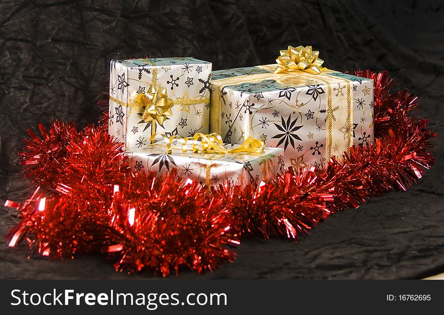 A wrapped Christmas gift surrounded by tinsel