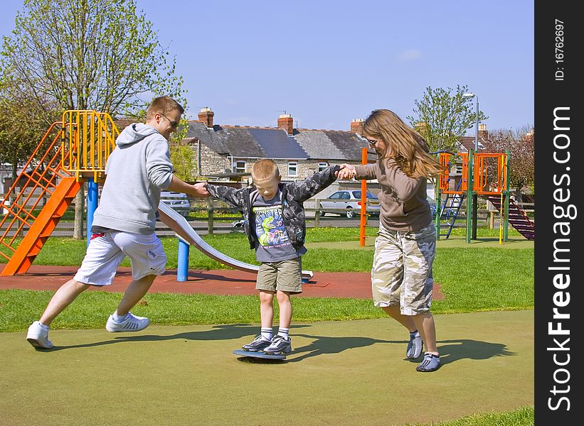 A young family play together in the park