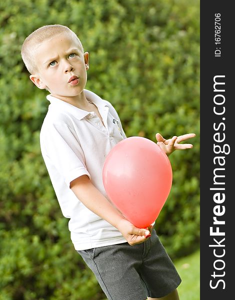 Six Year Old Boy Holding A Balloon