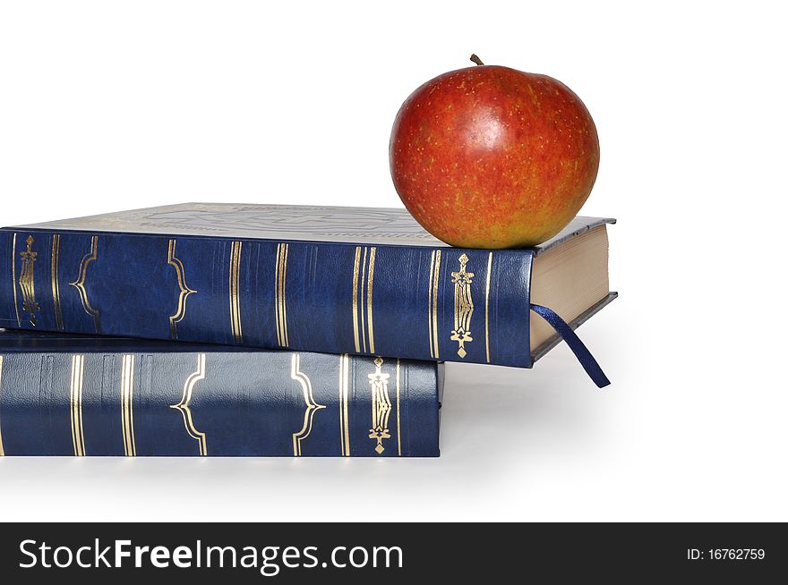 Two books and one red apple isolated on white. Two books and one red apple isolated on white