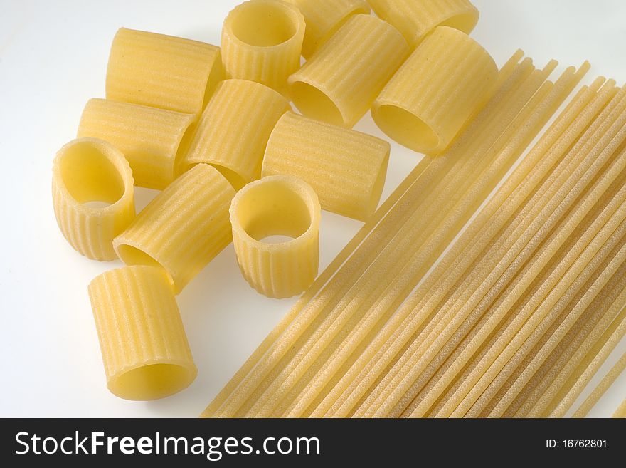 Spaghetti and macaroni on the white bottom. Spaghetti and macaroni on the white bottom