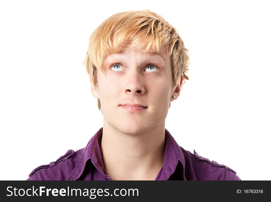 Young man looking above himself over white background
