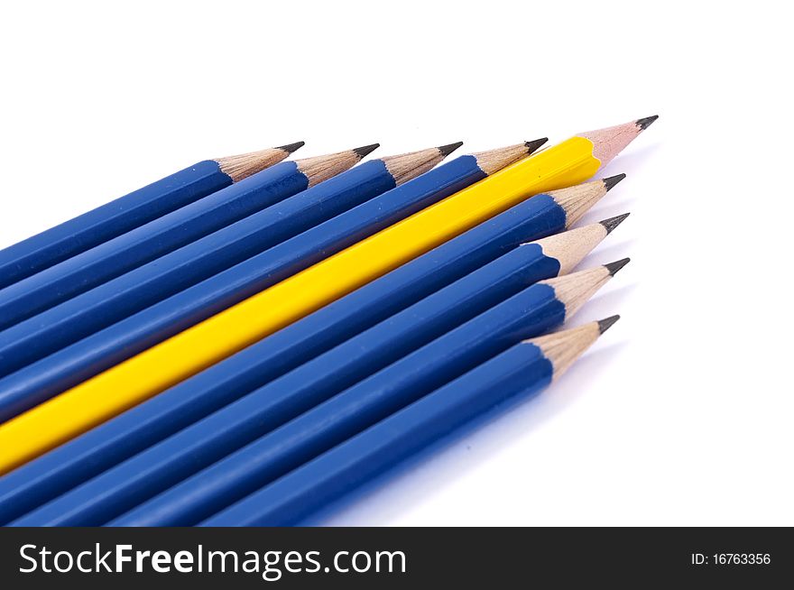 Row of pencils in form of arrow isolated over white