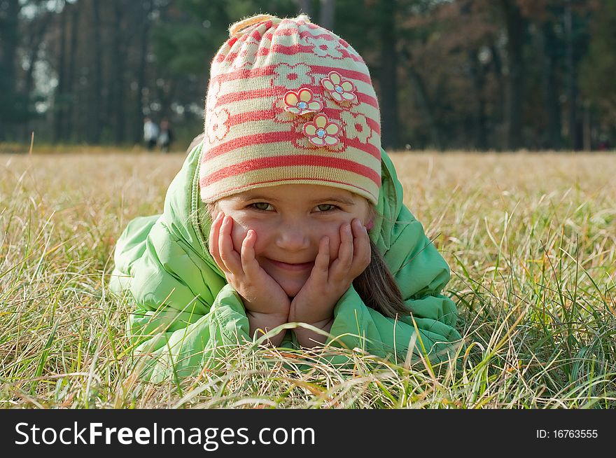 Little girl laying on the grass
