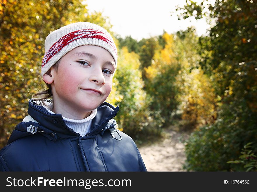 Portrait of a boy with a cheerful expression on his face.