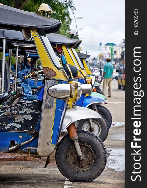 Thai Tuk tuk taxis waiting for hire