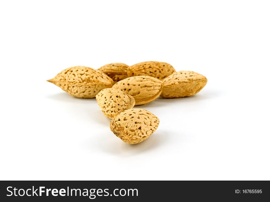 Heap of almonds on white background