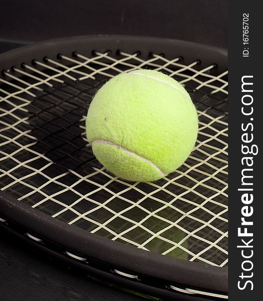 Tennis Ball on Racket On Gray