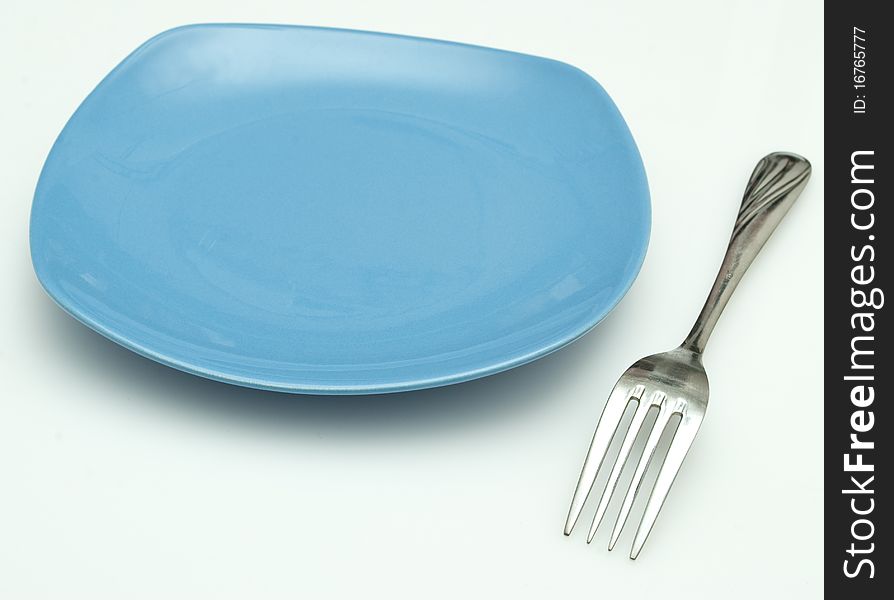 Plate and fork on the white background