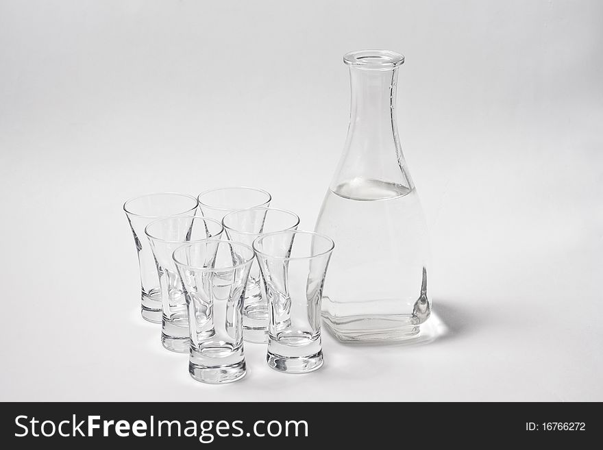 Decanter whith water and six glass on white background