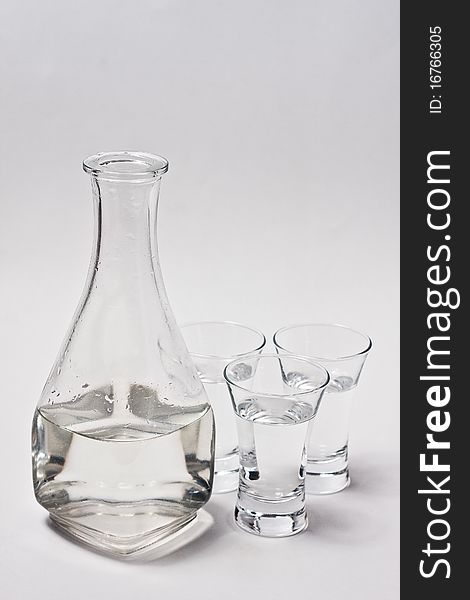 Decanter whith water and 3 glass on white background