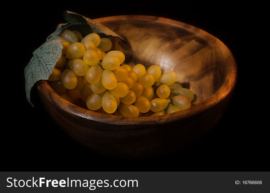 Picture of a still-life with fruit in a wooden dish