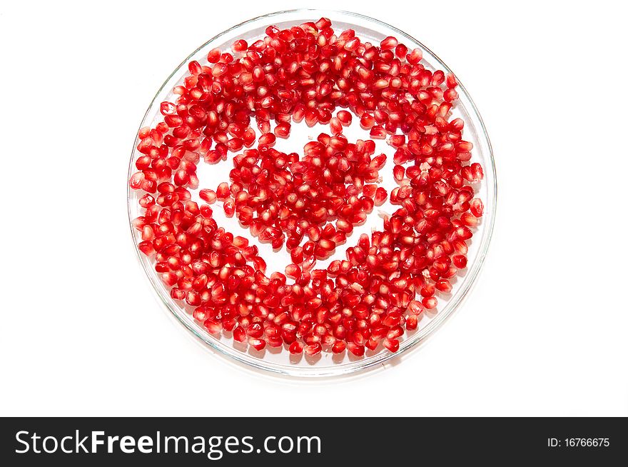 Heart made by pomegranate seeds on the plate. Heart made by pomegranate seeds on the plate