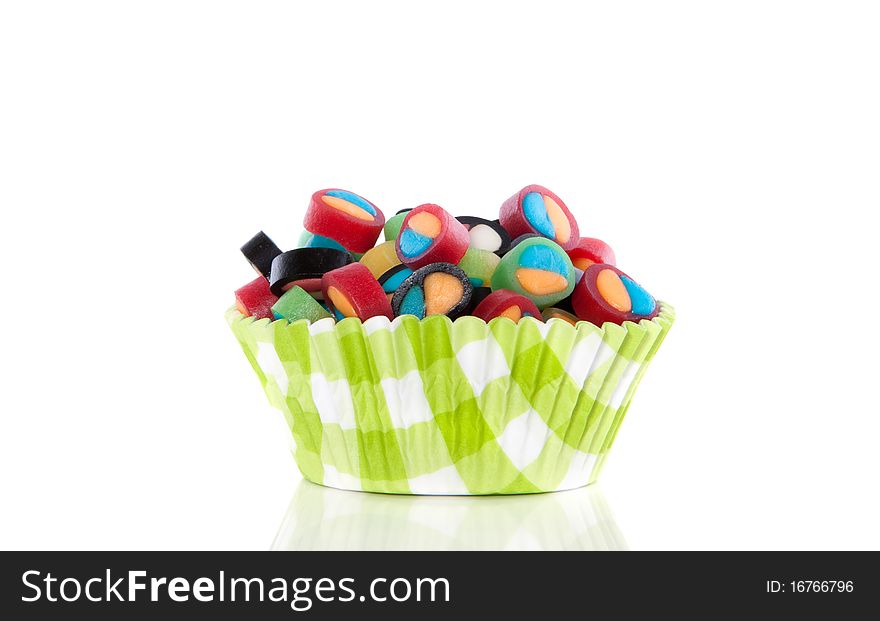 Colorful little candy in a modern cupake mold isolated over white. Colorful little candy in a modern cupake mold isolated over white