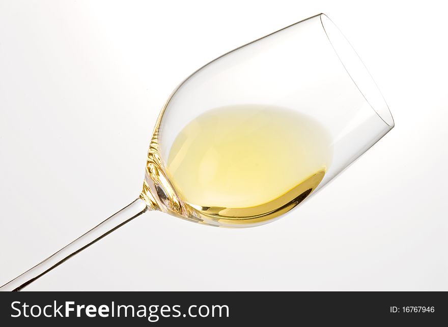 Glass of white wine and white background