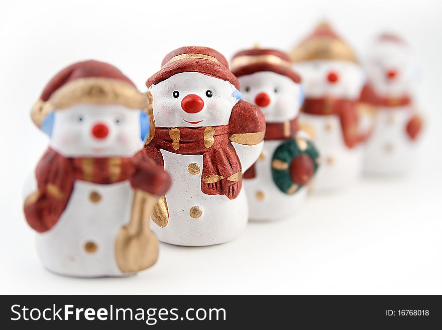 Figurines of snowmen on a white background. Figurines of snowmen on a white background