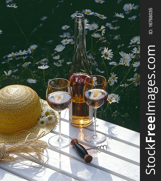 Glasses of rose wine with a hat on wooden table. Glasses of rose wine with a hat on wooden table