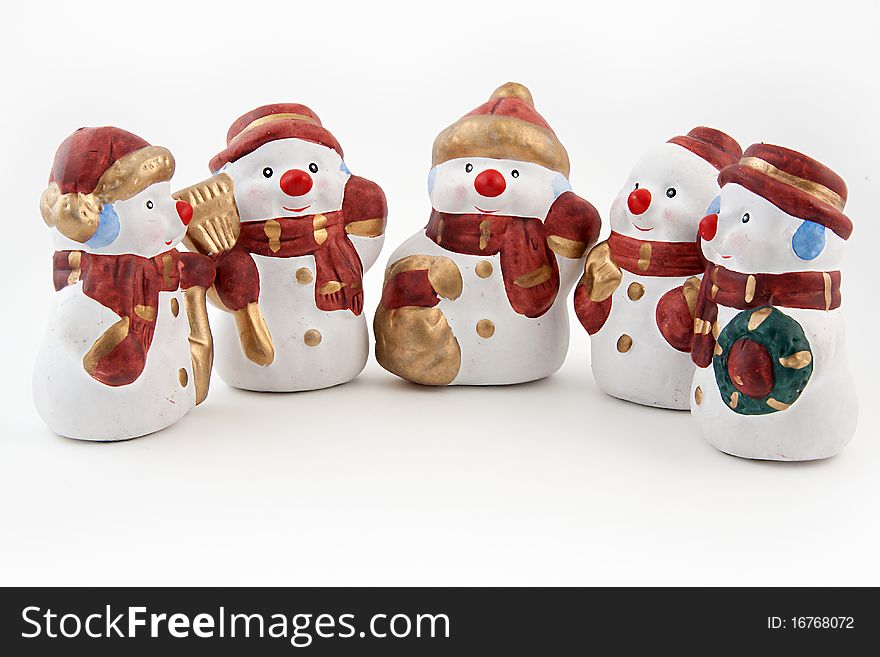 Figurines of snowmen on a white background. Figurines of snowmen on a white background