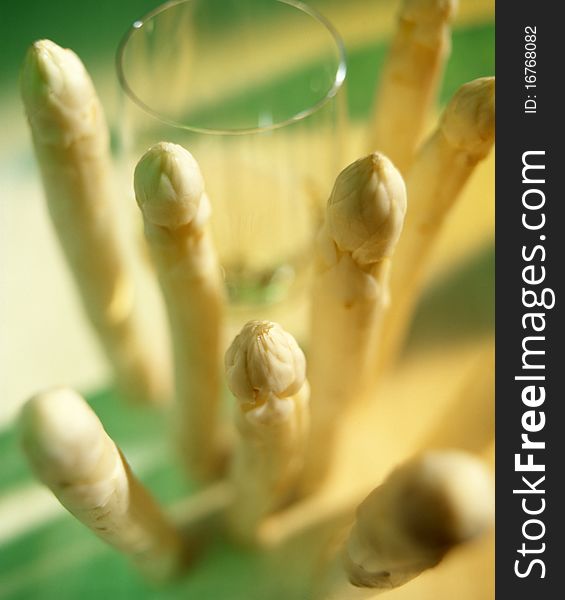 Glass of white wine with asparagus in an green and yellow ambiance