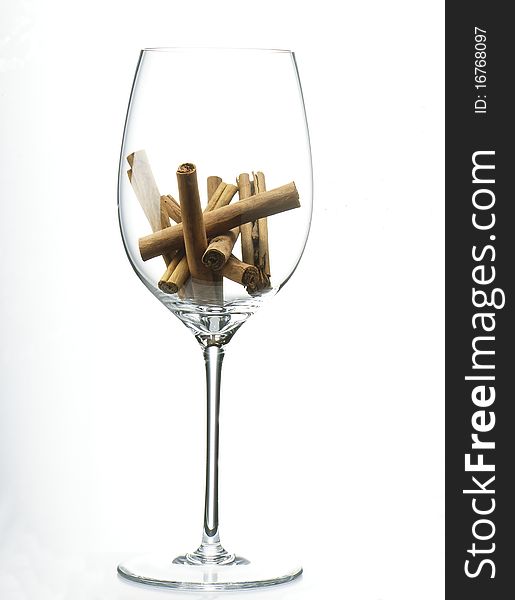 Sticks of cinnamon in a glass of wine