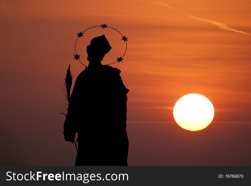 Statue of St John of Nepomuk in sunset