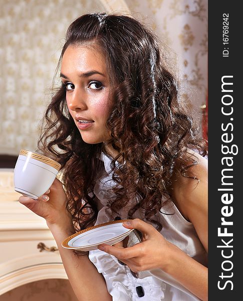 Young woman with white cup of hot drink. Young woman with white cup of hot drink