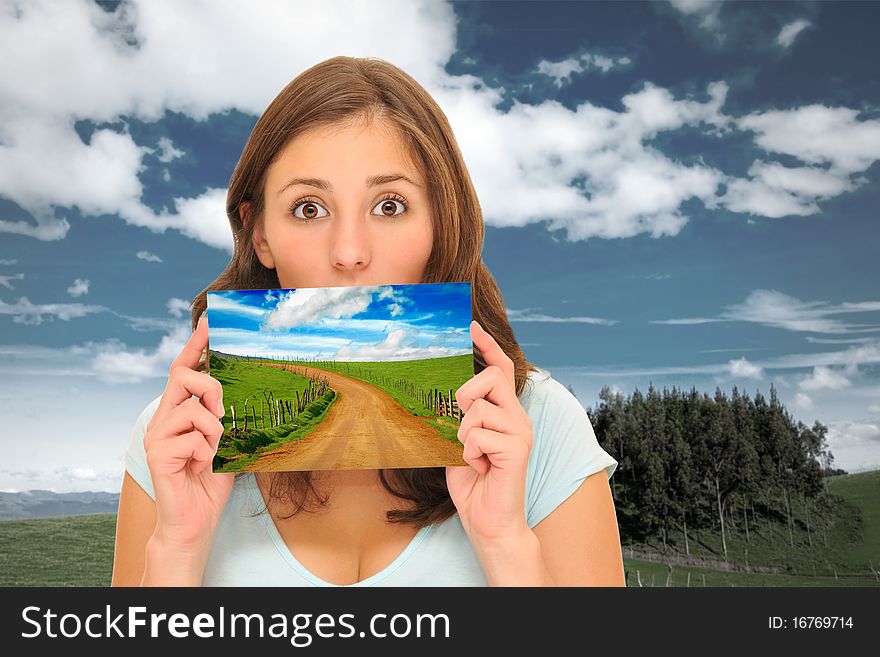 Beautiuful woman holding a perfect meadow road picture. Beautiuful woman holding a perfect meadow road picture