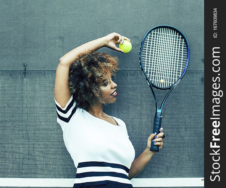 Young stylish mulatto afro-american girl playing tennis, sport healthy lifestyle people concept