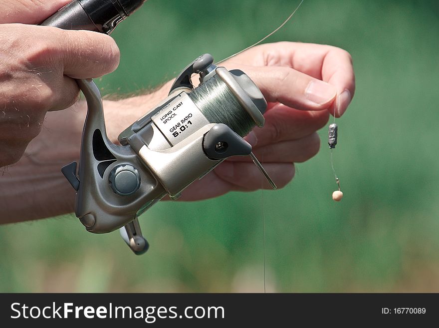 Closeup of a fisherman hand holding a fishing rod