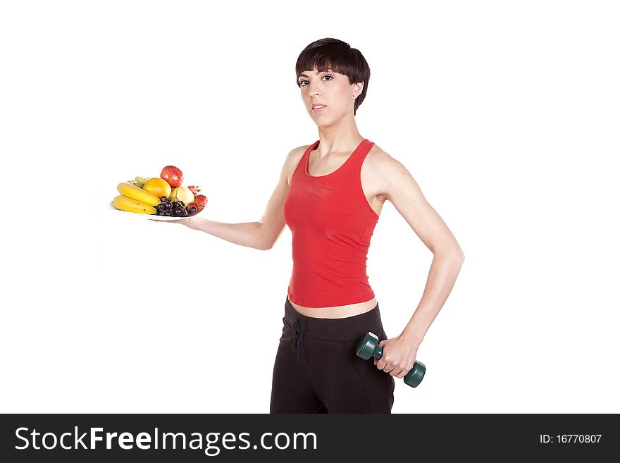 A woman holding a plate of fresh fruit with a weight showing how to be healthy. A woman holding a plate of fresh fruit with a weight showing how to be healthy.