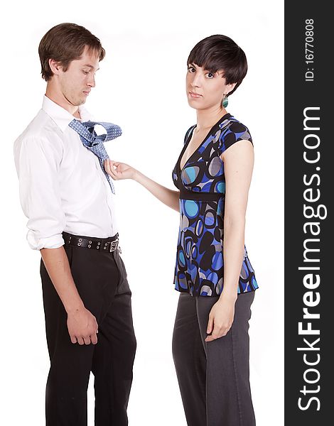 A woman looking at camera with a serious expression sick of trying to tie her man's tie. A woman looking at camera with a serious expression sick of trying to tie her man's tie.