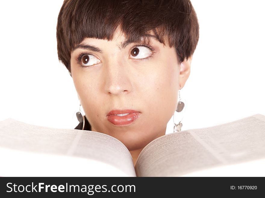 A woman looking away while holding a book up to her face. A woman looking away while holding a book up to her face.