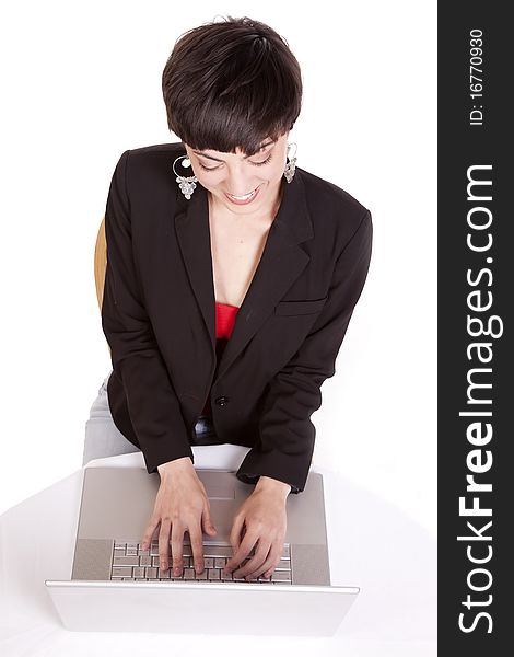 A woman looking down working on her laptop. A woman looking down working on her laptop.