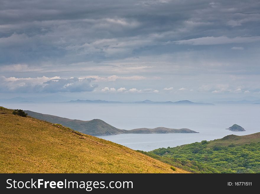 Russian Primorye seabank. near Vladivostok. Andreevka village.The mysterious island in the blue sea. Russian Primorye seabank. near Vladivostok. Andreevka village.The mysterious island in the blue sea