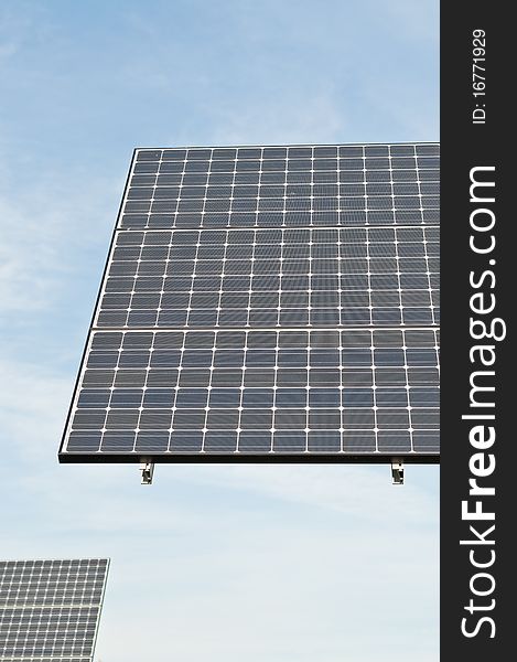 Photovoltaic solar panel arrays with blue sky and white clouds in the background. Photovoltaic solar panel arrays with blue sky and white clouds in the background.