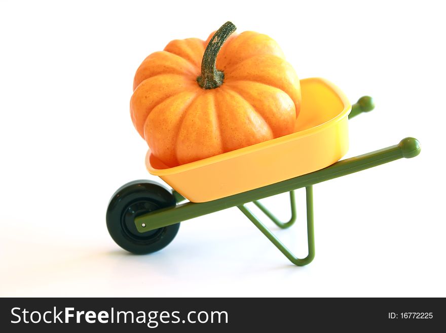 Isolated Orange Pumpkin In Wheelbarrow