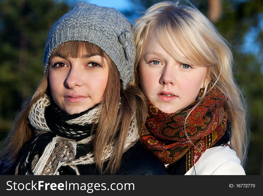 Portrait two young beautiful girls in wood