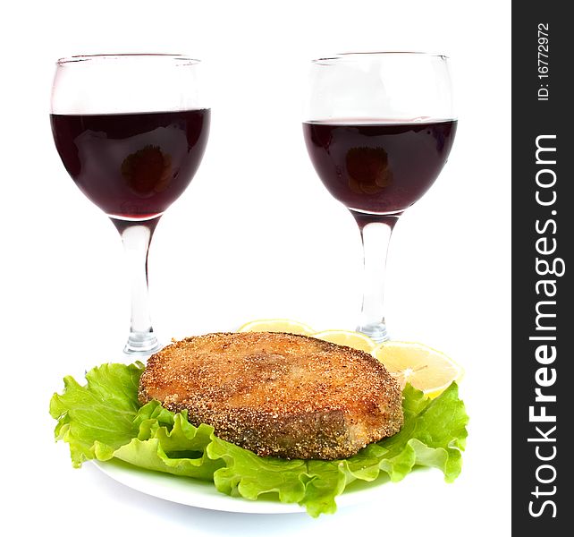 Grilled fish and a glass of wine on a white background