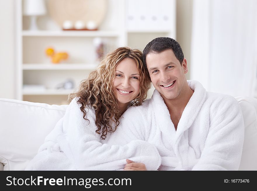 Laughing attractive couple in dressing gowns. Laughing attractive couple in dressing gowns