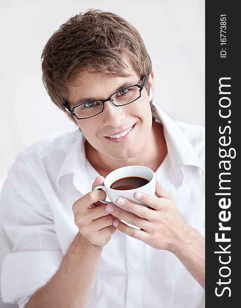 Portrait of a young man with a cup of coffee
