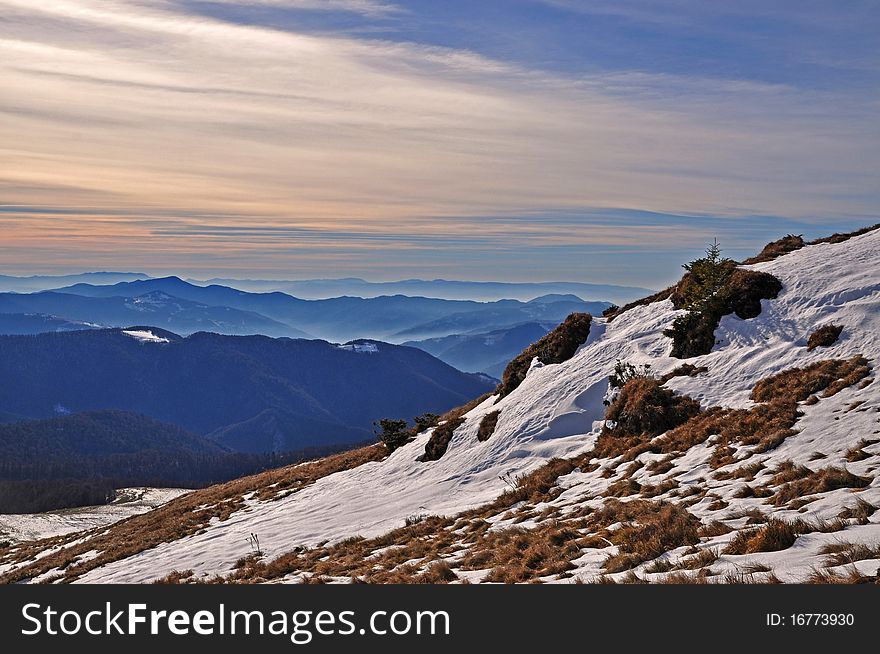 Autumn evening in mountains in a landscape with the cloudy sky in beams of the coming sun. Autumn evening in mountains in a landscape with the cloudy sky in beams of the coming sun.