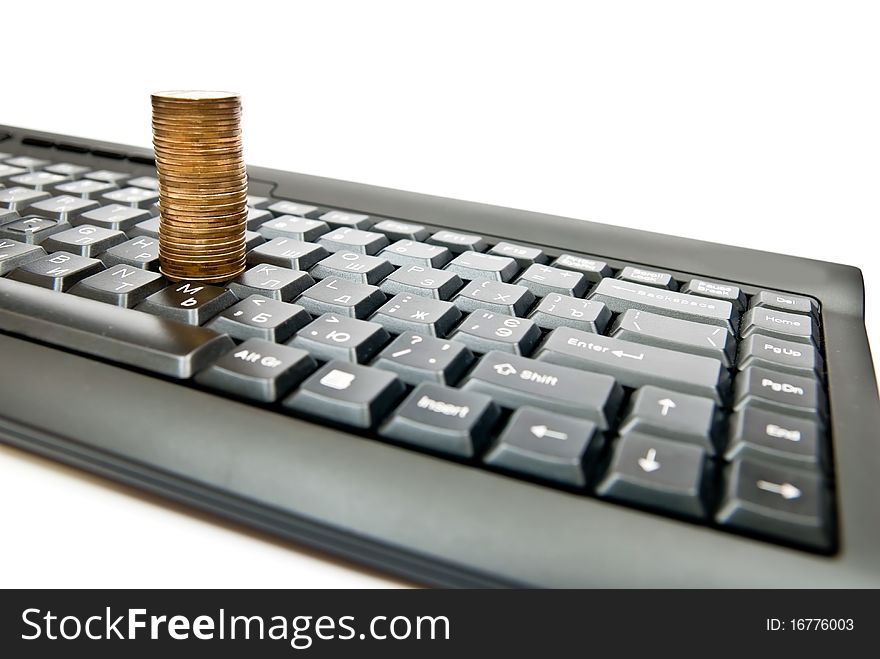 Heap of yellow coins on black keyboard. Heap of yellow coins on black keyboard