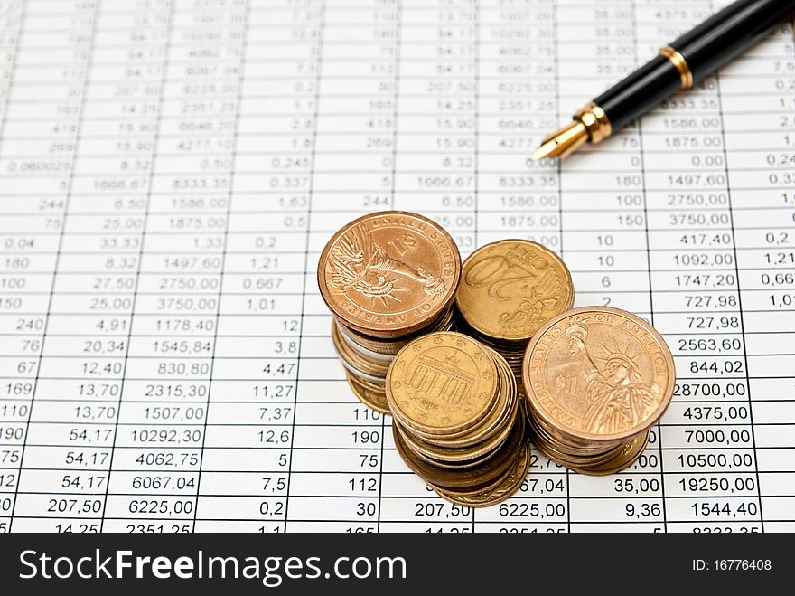 Financial document with numbers with coins stacks. Financial document with numbers with coins stacks
