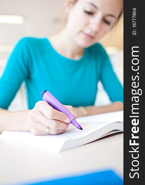 Pretty young college student in a library (shallow DOF; color toned image)