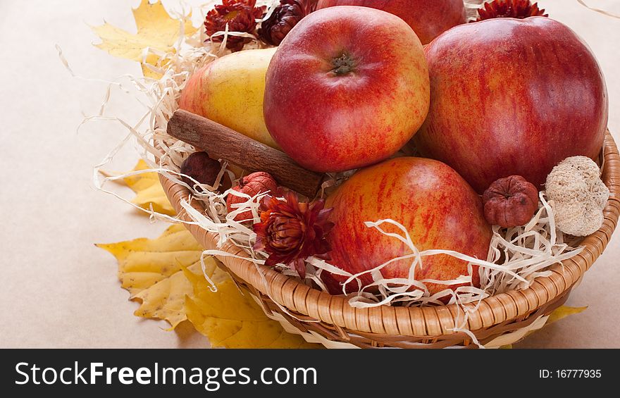 Apples in a wicker basket on table. Apples in a wicker basket on table