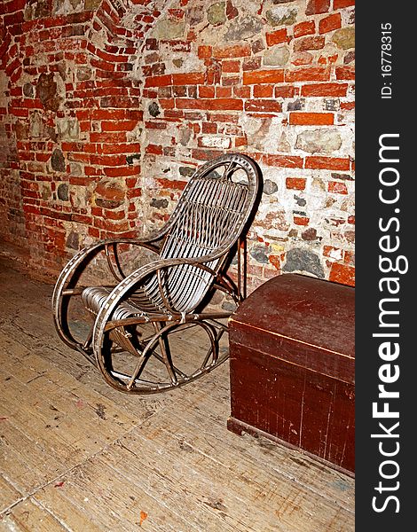 A old rocking chair and red wall