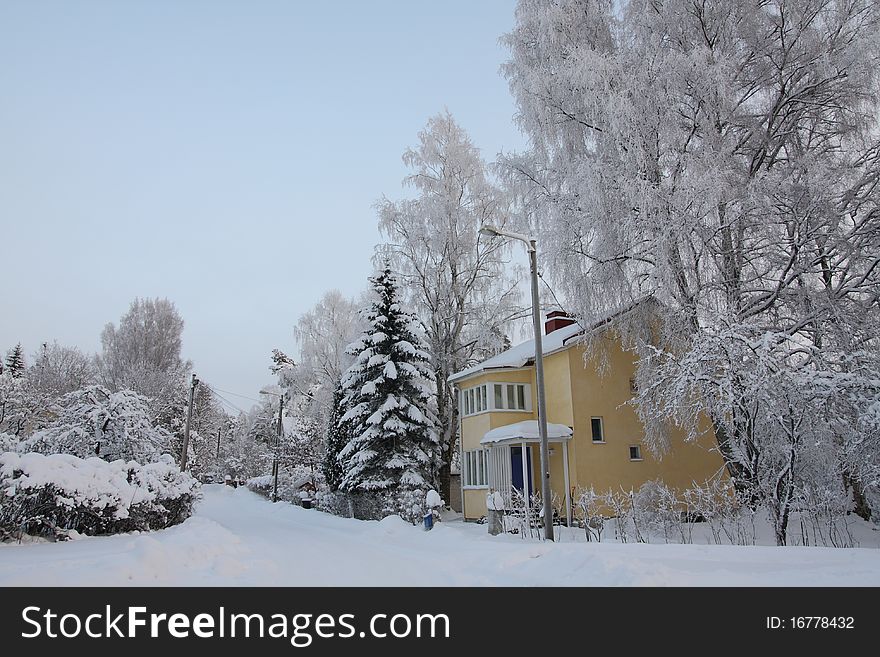 Wooden Finnish house in winter covered with snow