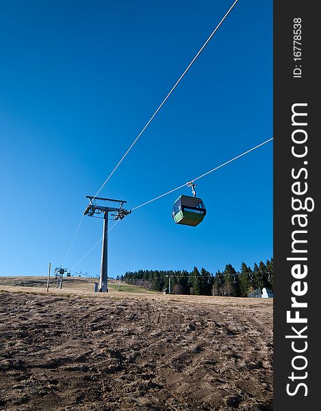 Ropeway with no snow on mountain and blue sky. Ropeway with no snow on mountain and blue sky