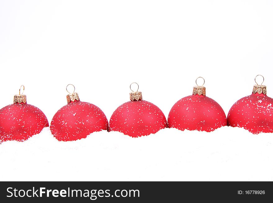 Blue and red matt christmas balls on snow on white background